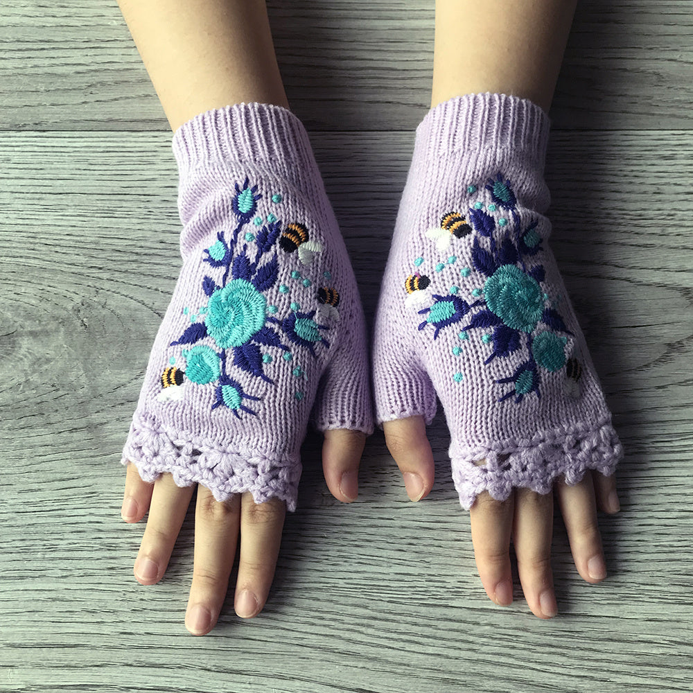 Comfortable women's knit fingerless gloves, adorned with delicate floral hand embroidery for winter fashion.