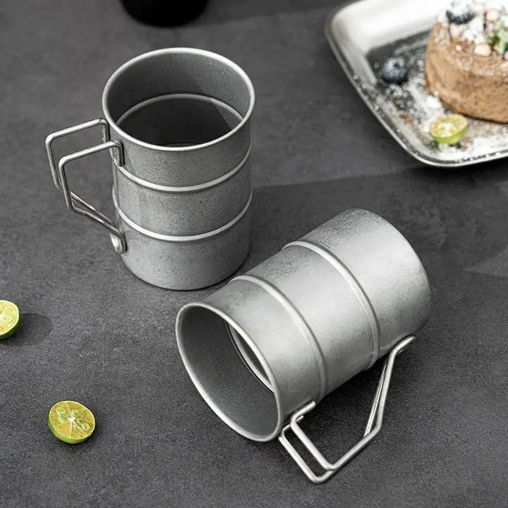 Retro-style 13 fl oz stainless steel camping mug. Reusable, portable drinkware for coffee & tea enthusiasts.