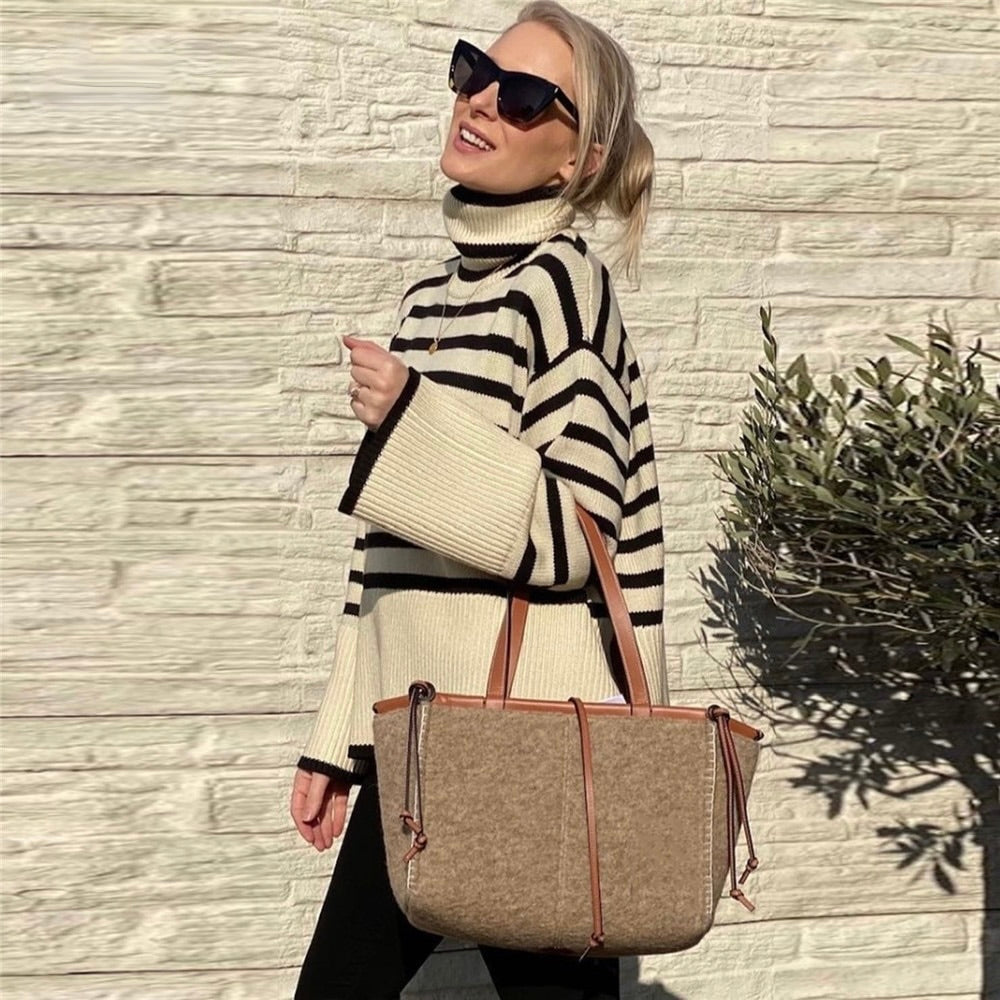 Versatile women's cozy turtleneck sweater in a neutral shade, perfect for chic fall and winter fashion looks.