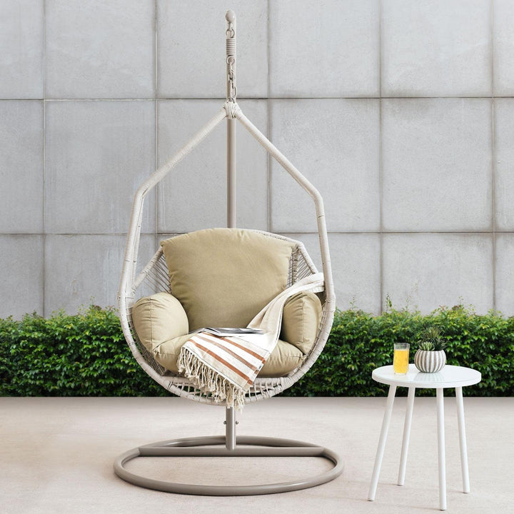 Stylish cream steel frame hanging egg chair swing, perfect patio furniture with comfy removable cushion.