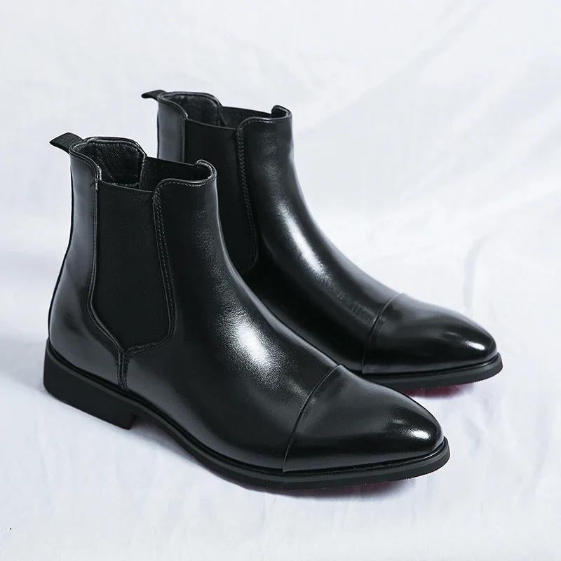 Stylish men's slip-on ankle boots, black leather Chelsea design with eye-catching red sole detail.