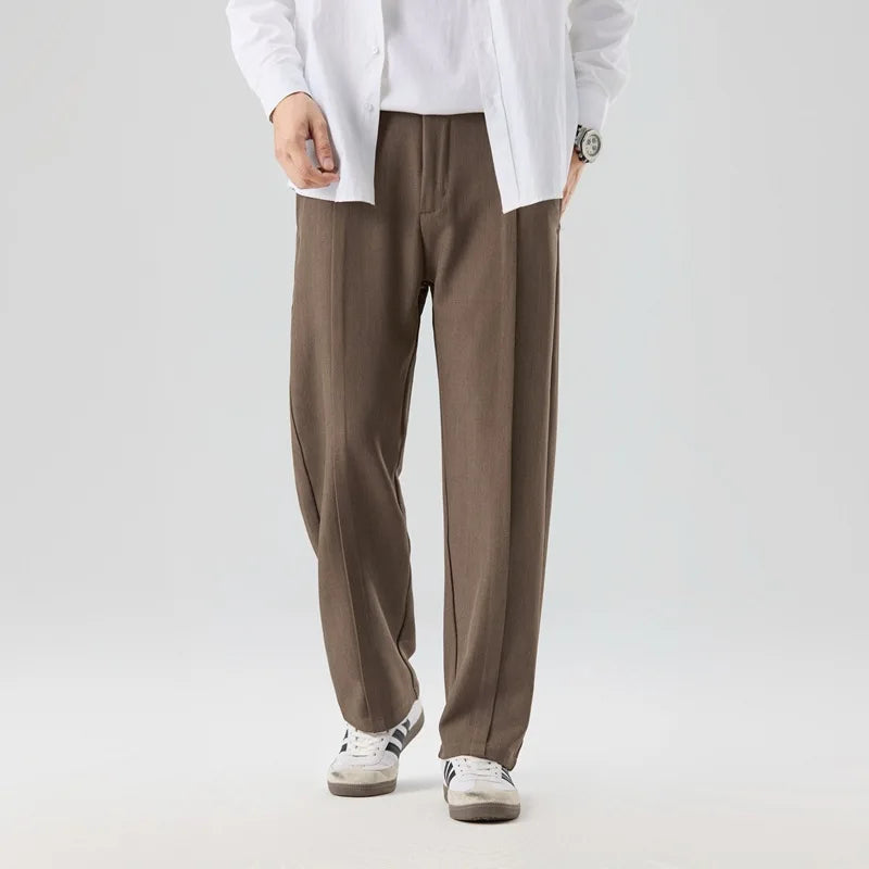 Gray men's pleated drape trousers offering refined comfort & versatile style for modern men.
