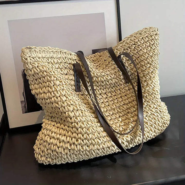 Spacious women's oversized straw beach tote, perfect for a stylish summer getaway.