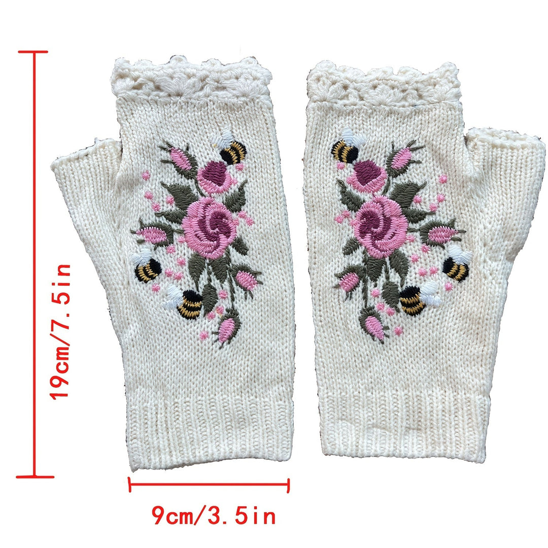 Close-up of hand-embroidered floral detail on cozy knit women's fingerless gloves, perfect winter accessory.