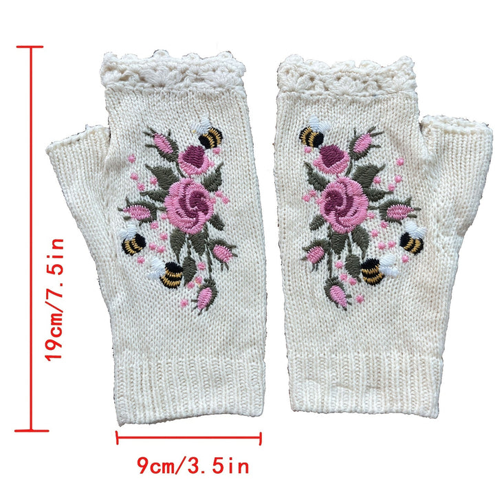 Close-up of hand-embroidered floral detail on cozy knit women's fingerless gloves, perfect winter accessory.