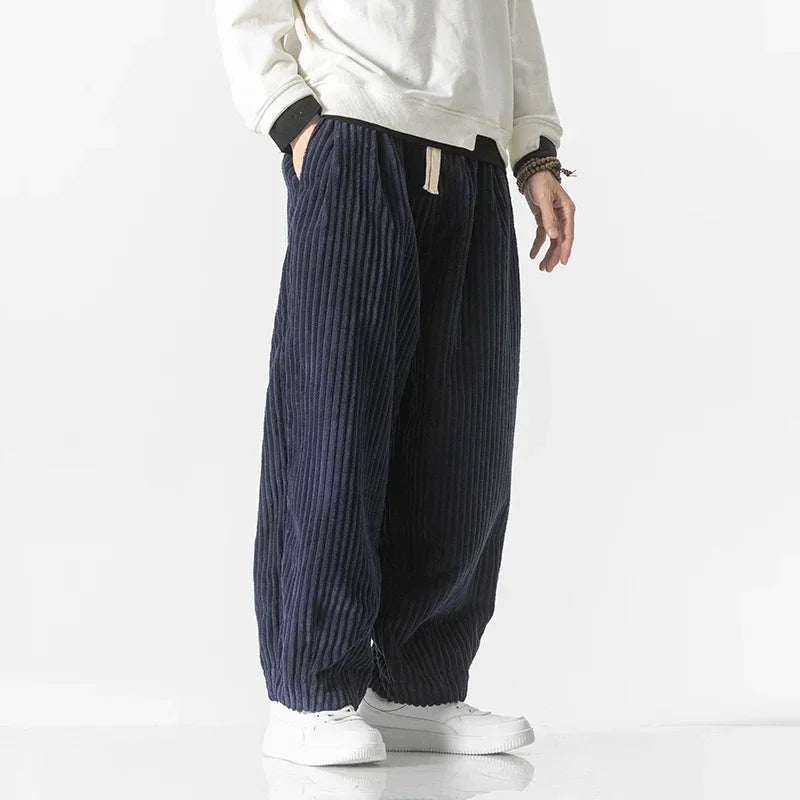 Man wearing stylish men's wide-leg joggers in a casual setting, showcasing comfortable and versatile loungewear.