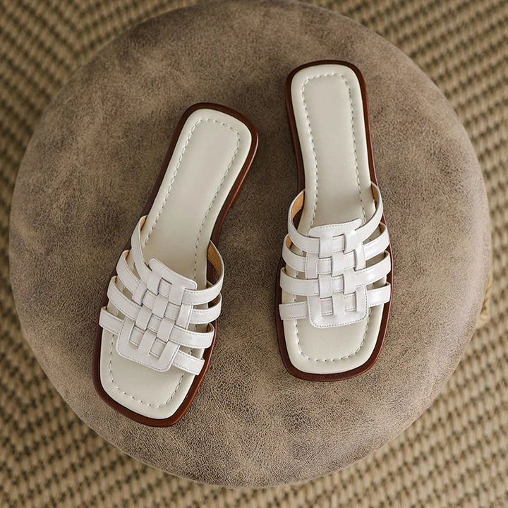 Women's Tivra slide sandals, flat sole, open toe, geo cutout design for stylish and comfortable everyday wear.