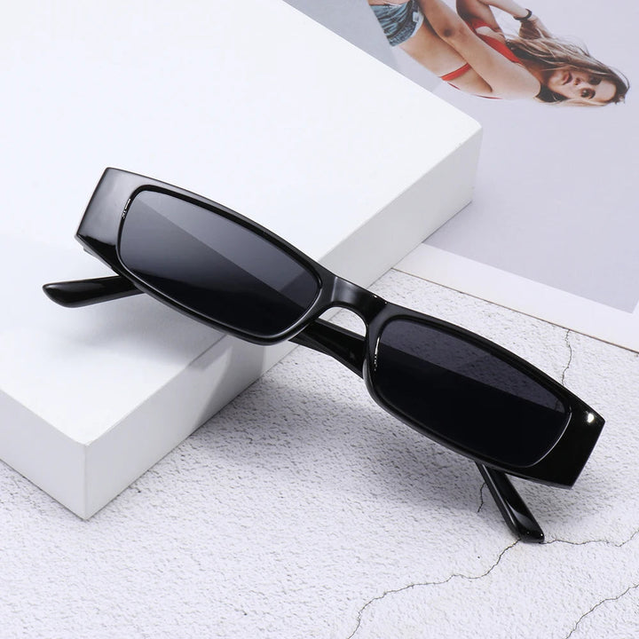 Stylish women's sunglasses: bold, futuristic retro slim shades offering UV400 protection.