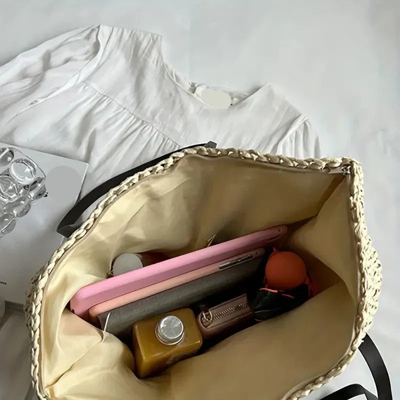 Beautifully crafted women's oversized straw beach tote, a must-have for summer fashion.