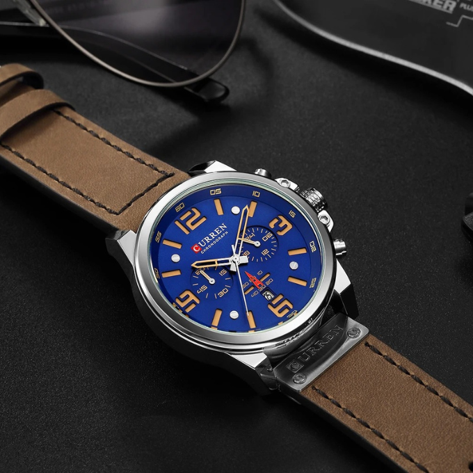 Men's dress watch: silver-tone chronograph with a deep blue dial & brown leather strap.