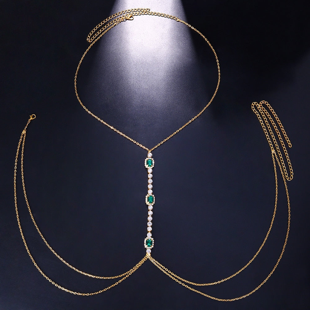 Gold-tone women's green crystal chest chain, a radiant rhinestone body jewelry accessory perfect for special occasions.