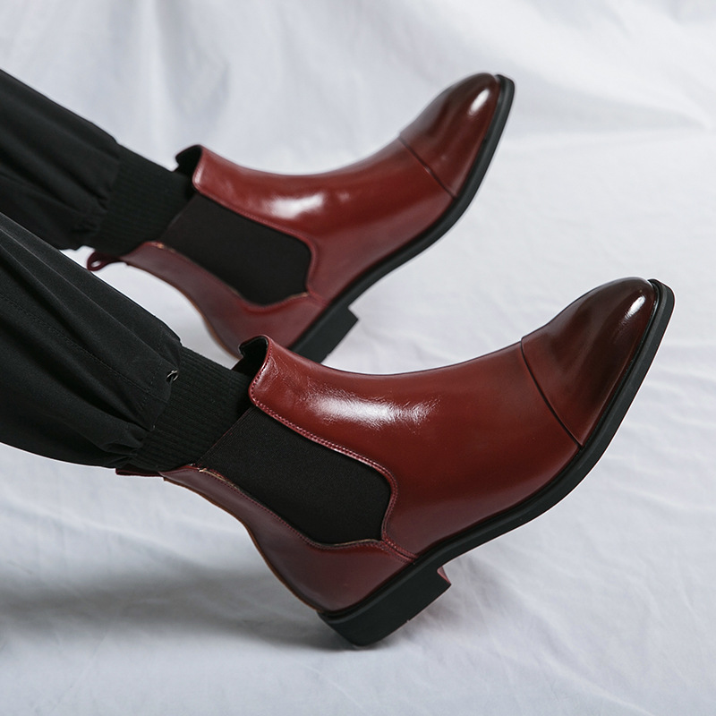 Elegant men's slip-on ankle boots, black Chelsea design, perfect for dressy or casual looks, red sole.
