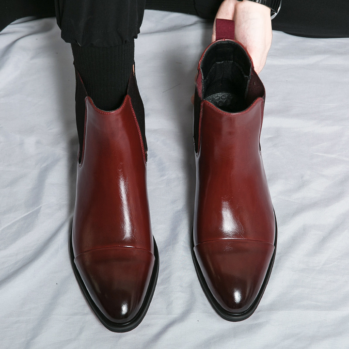Men's formal black Chelsea boots, high-quality leather, designed for comfort and style with a red sole.