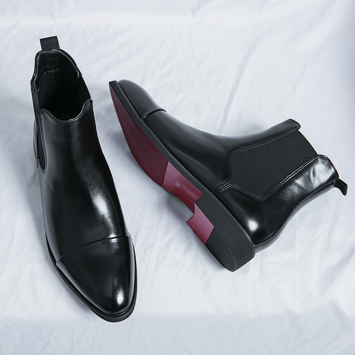 Formal men's black Chelsea dress boots with unique signature red sole. Ideal for sophisticated looks.