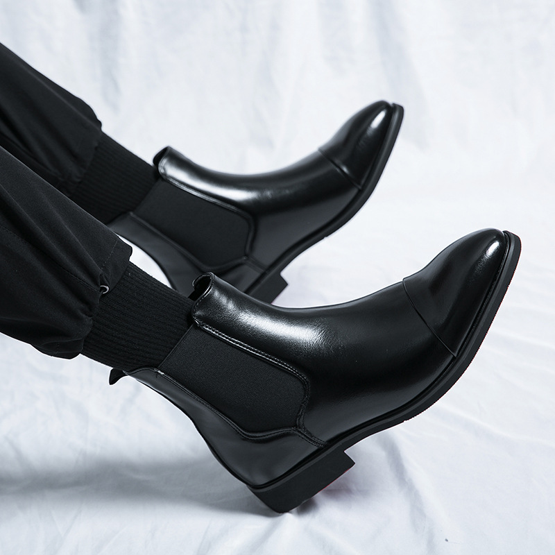 Versatile men's black Chelsea boots for formal or casual outfits, featuring a distinctive red sole.