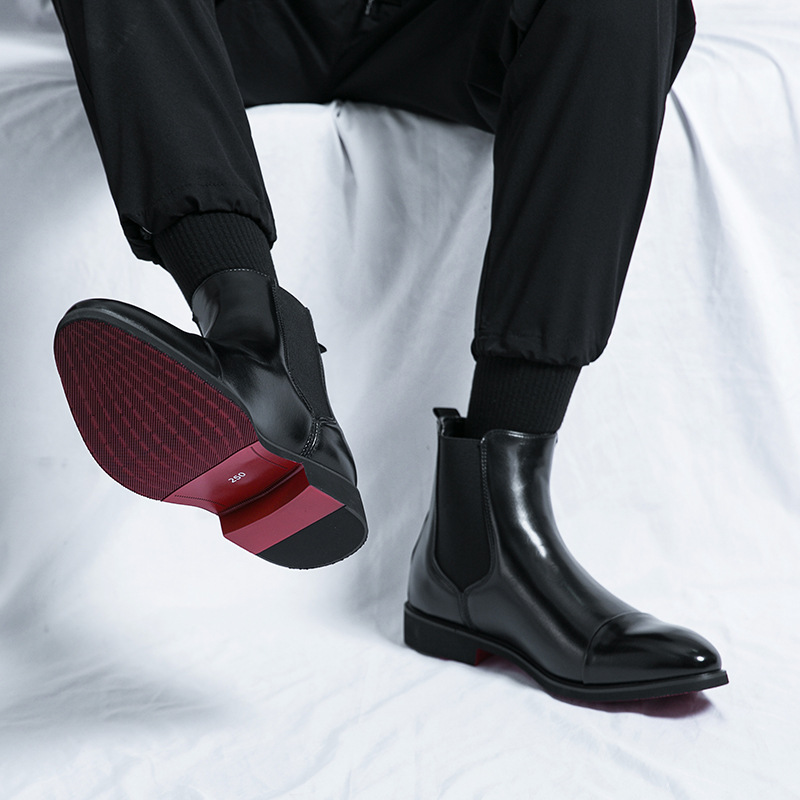 Sophisticated men's ankle boots, black leather Chelsea style, ideal for modern men, red sole accent.