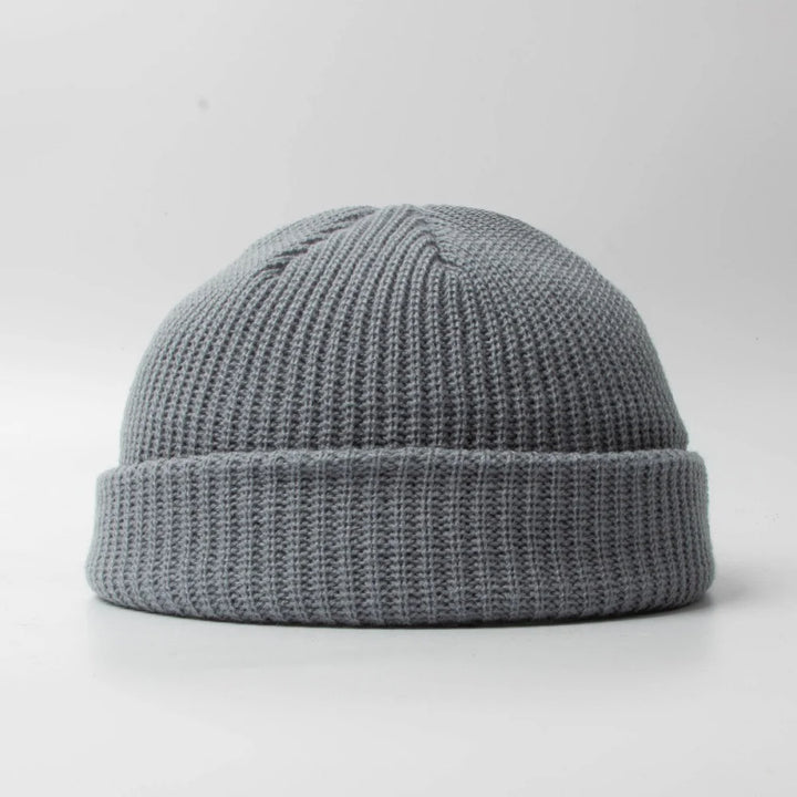Close-up of a textured knit unisex skull cap beanie, soft & warm winter accessory.