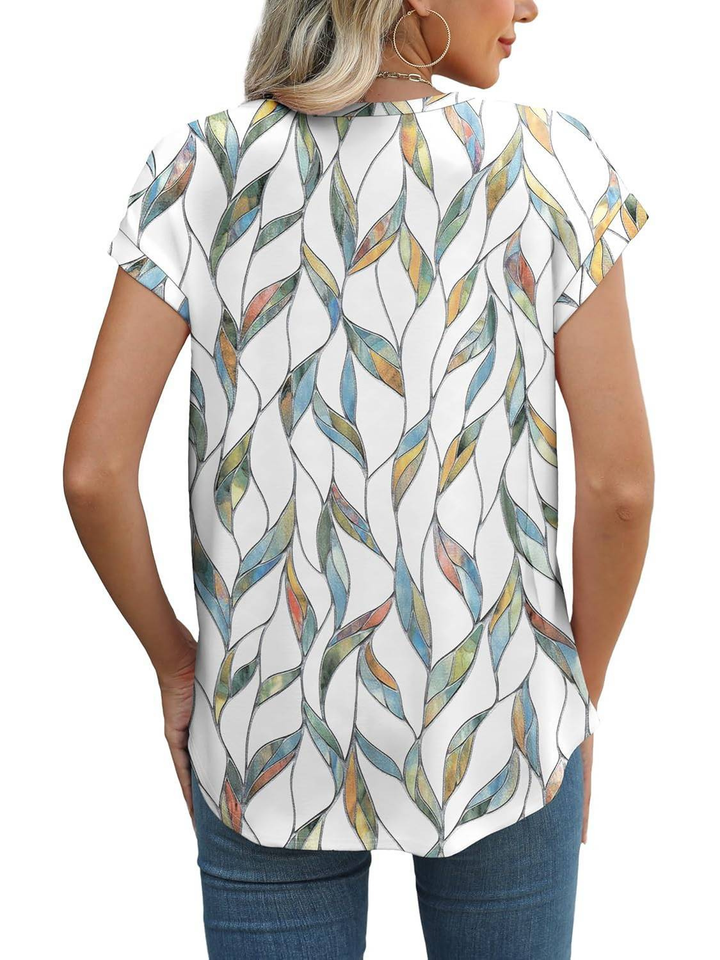 Stylish women's summer top featuring vibrant botanical leaf print and cap sleeves.