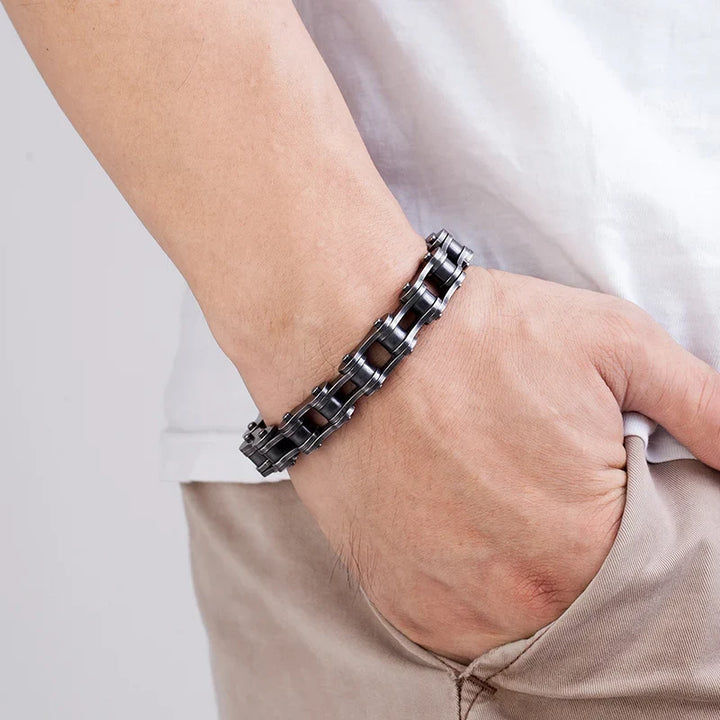 Close-up of a men's vintage black stainless steel chain bracelet, showcasing intricate links & polished finish.