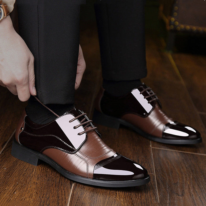 Close-up of elegant men's two-tone oxford dress shoes with classic lacing and detailed stitching.