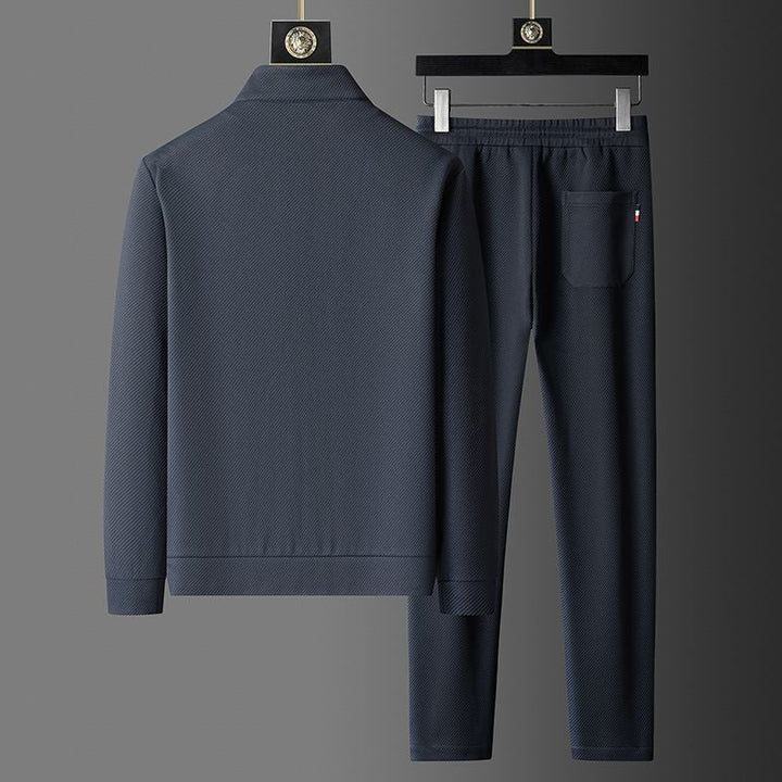 Matching men's tracksuit set in deep black & royal navy, ideal for sportswear, loungewear & active days.