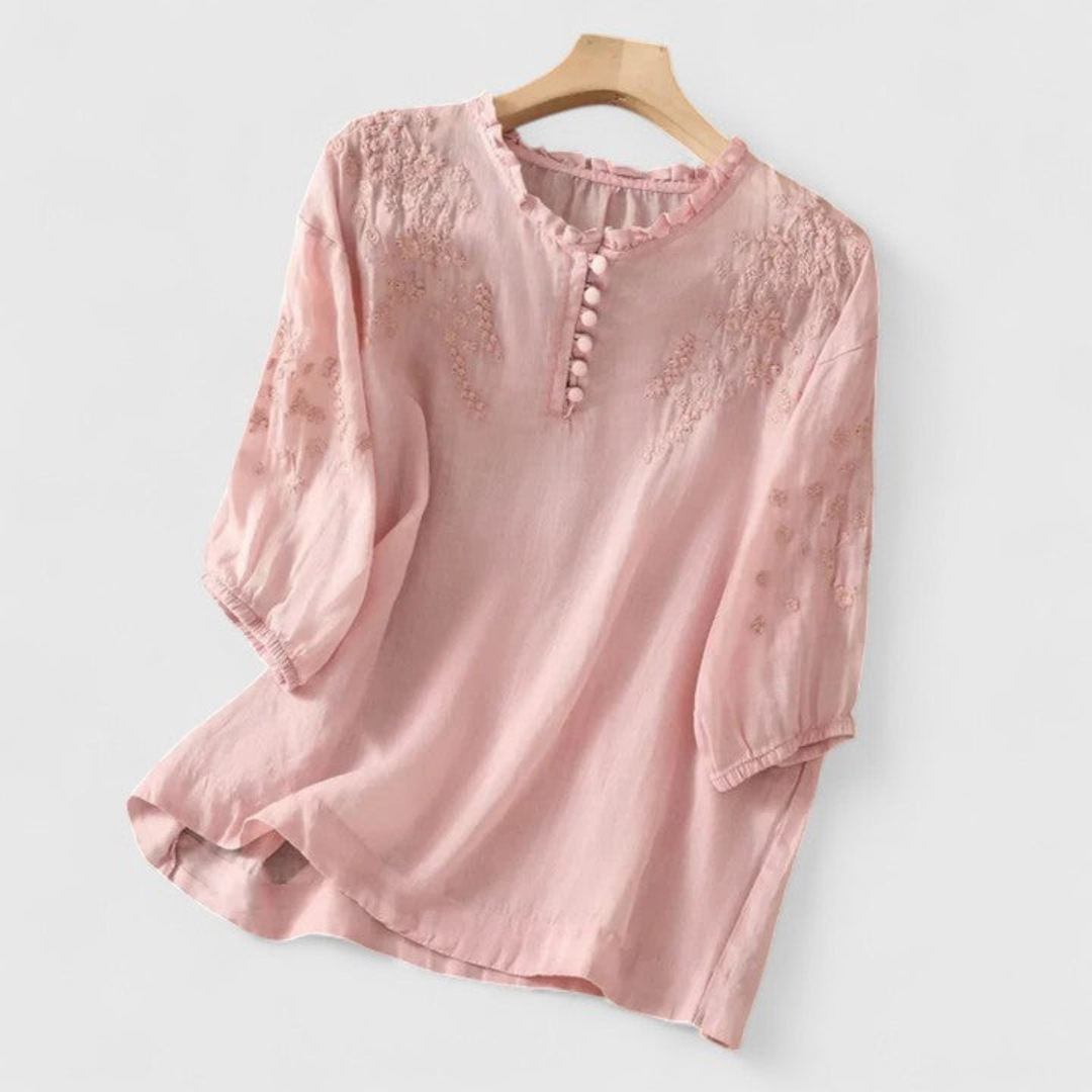 Women's embroidered three-quarter sleeve blouse with a stylish ruffle collar & fun pom-poms. Ideal for summer tops.
