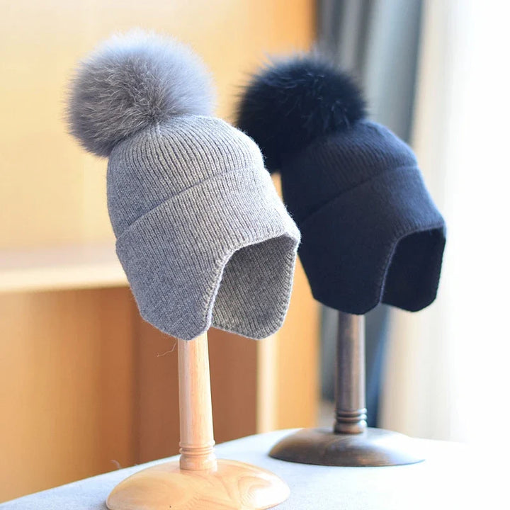 Fluffy pom-pom beanie for unisex wear. Super warm winter hat, perfect for staying cozy and stylish in cold weather.