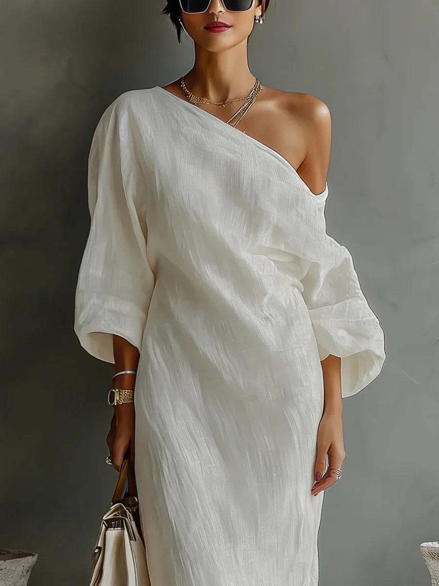 White women's one shoulder asymmetrical dress with a relaxed fit, batwing sleeve, and convenient side pocket.