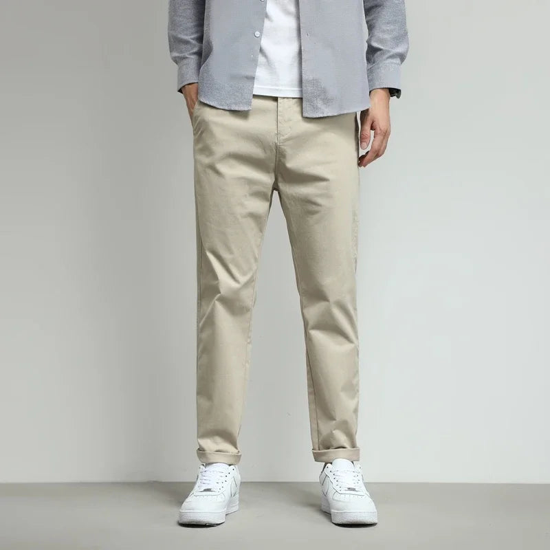 Green men's performance stretch pants. Wrinkle-free and water-resistant tech trousers for active use.