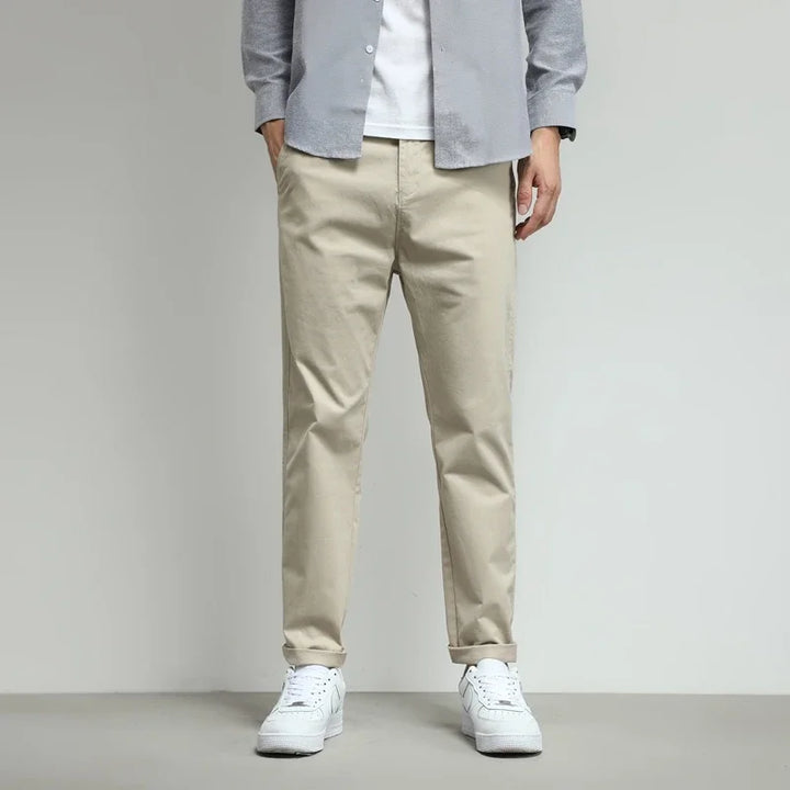 Green men's performance stretch pants. Wrinkle-free and water-resistant tech trousers for active use.
