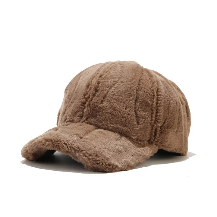 Warm women's plush faux fur winter cap, providing cozy comfort and stylish headwear.