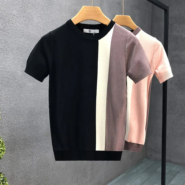 Modern men's color block crewneck sweater in black and pink. A versatile, stylish long sleeve top for casual outfits.