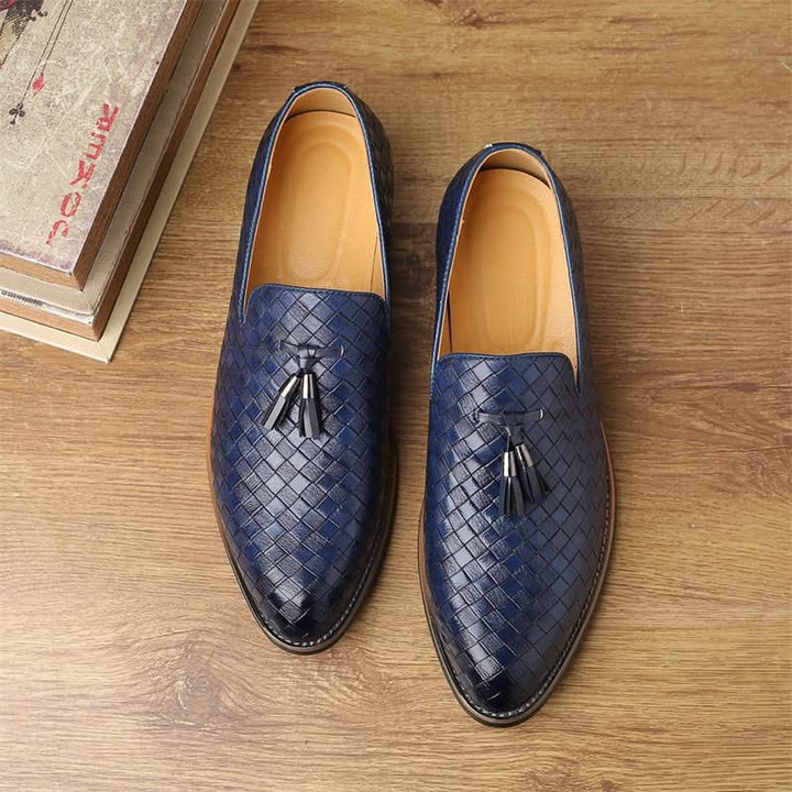 Detailed shot of the woven texture on men's tassel loafers. Premium slip-on dress shoes.