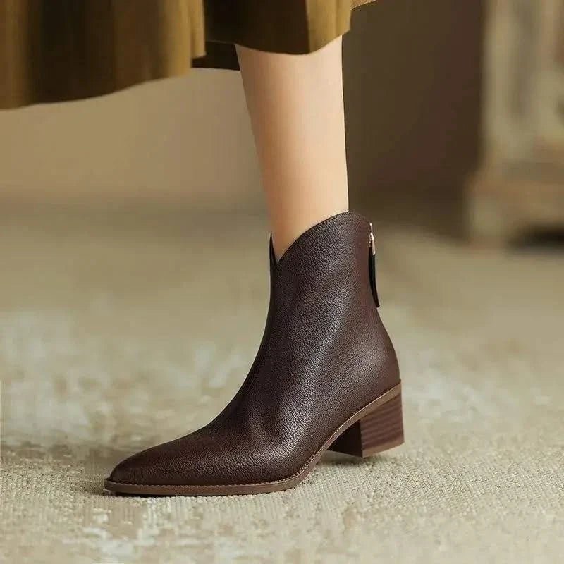 Fashionable women's ankle boots featuring a sleek pointed toe and practical low heel.