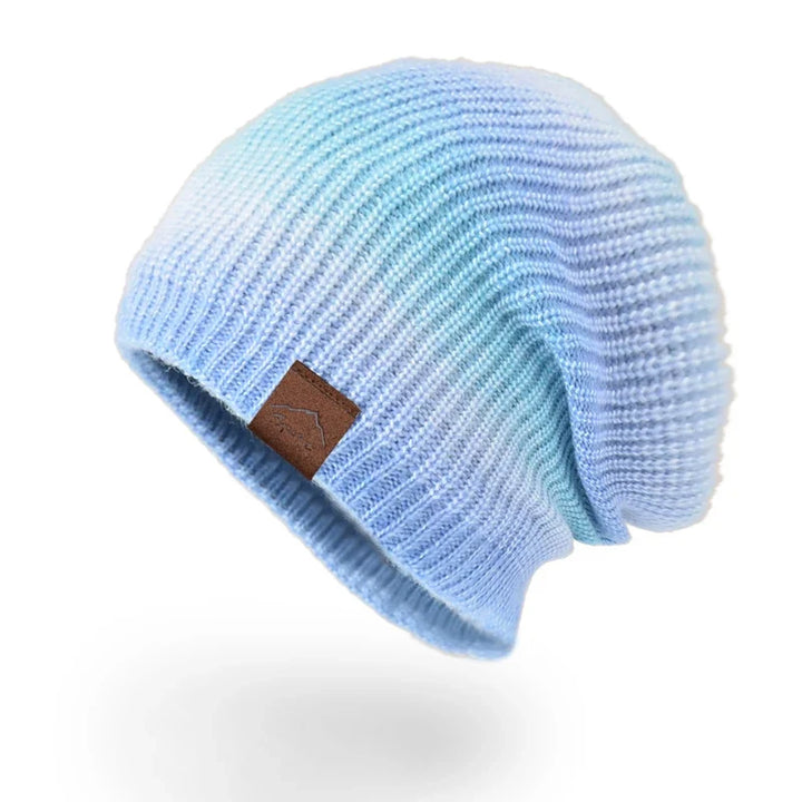 Eye-catching rainbow knit beanie, providing unisex warmth and a vibrant style for winter.