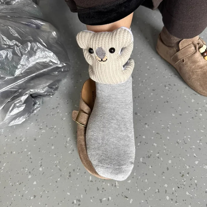 Soft, fluffy animal house socks with a non-slip sole, providing cozy comfort for all adults at home.