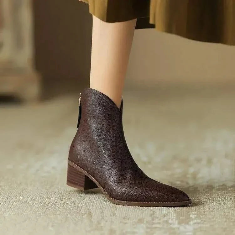 Women's stylish black pointed toe ankle boots with low heel, perfect for everyday chic fashion.