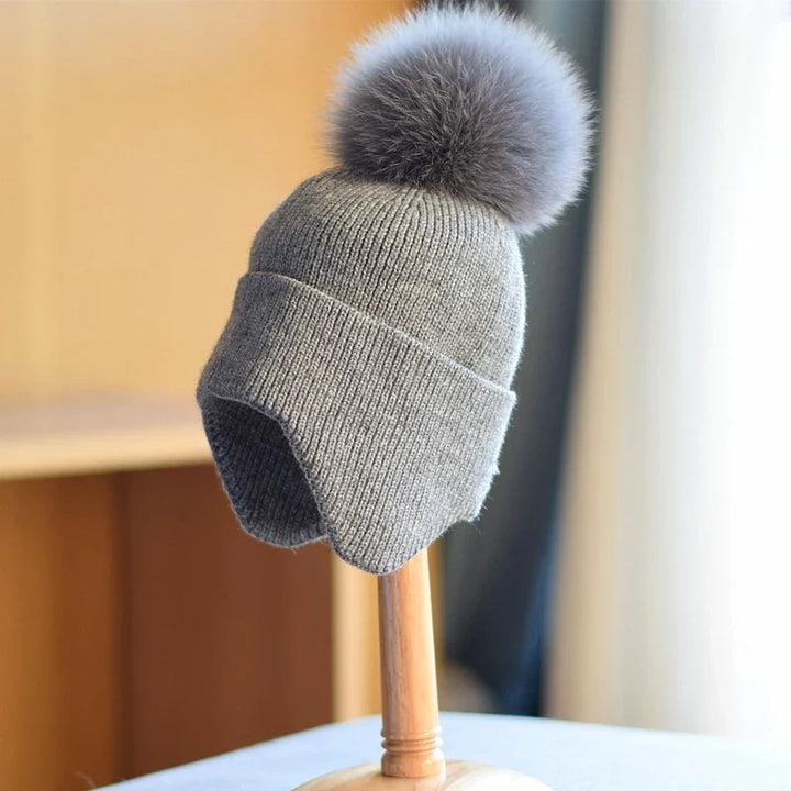 Cozy unisex knit pom beanie hat in a soft, warm material. Ideal winter apparel accessory for all.