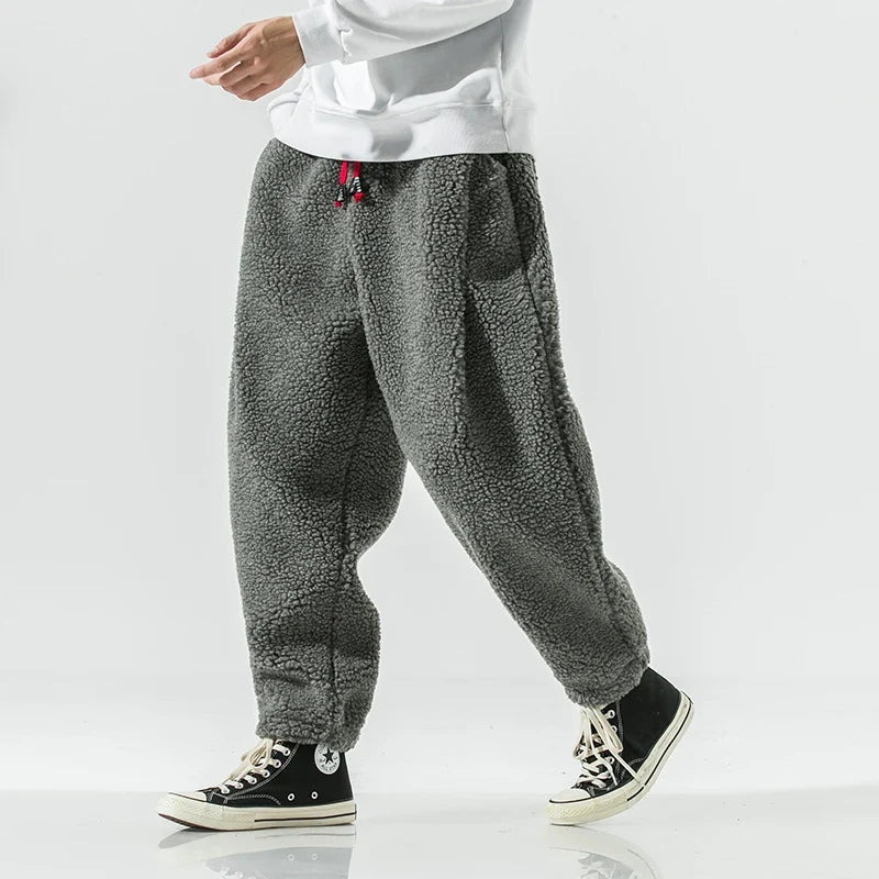 Close-up of soft men's sherpa joggers, showcasing plush texture & warm fabric. Ultimate comfort for men's fashion.