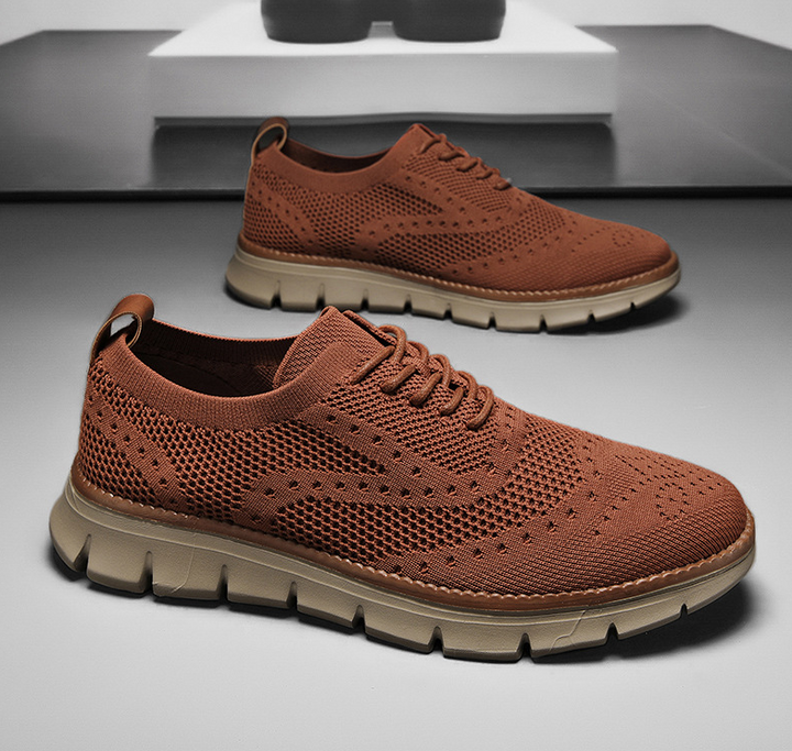 Lightweight men's sneakers with brogue design, offering versatile dress shoe style.