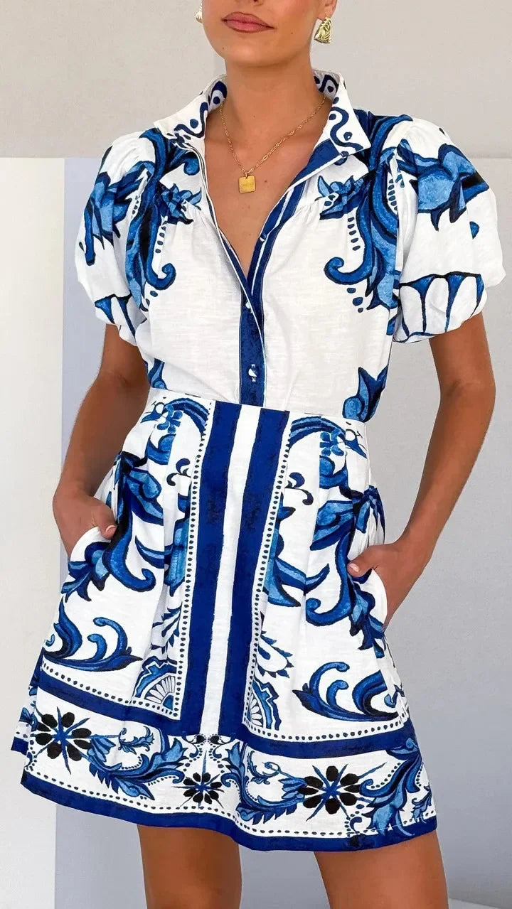 Elegant women's floral day dress with vibrant print and delicate puff sleeves.