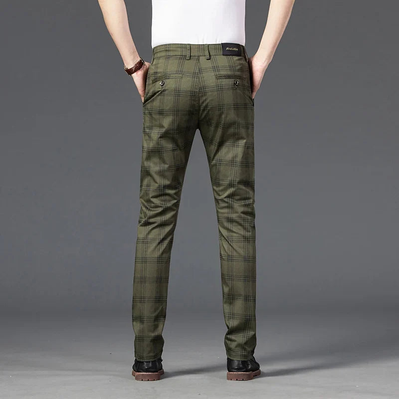 Close-up of men's grey plaid slim fit dress pants, highlighting the pattern and stretch material for comfort.