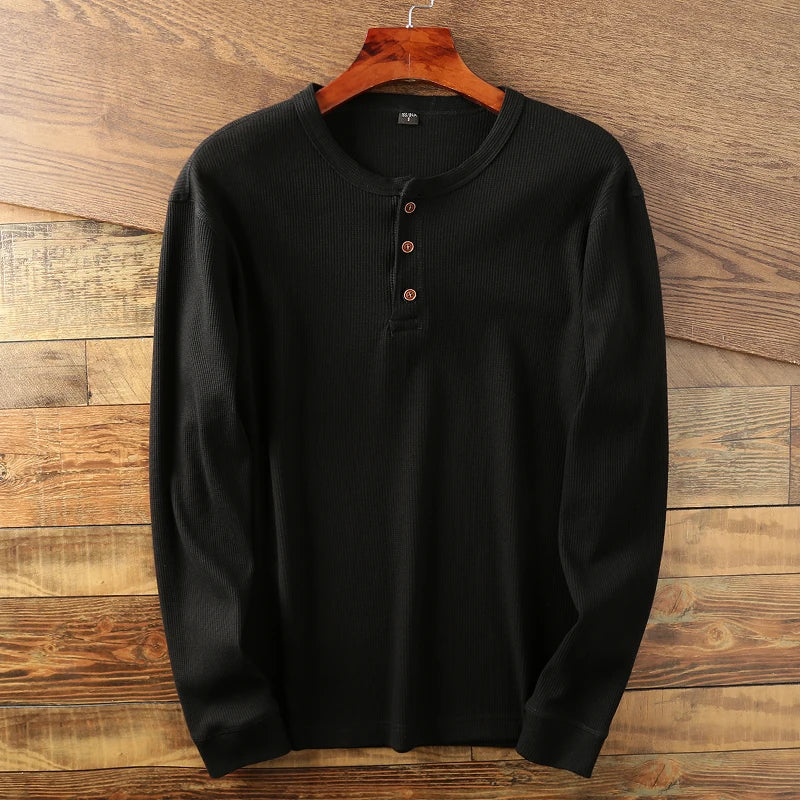 Man in a comfortable men's classic waffle knit long sleeve shirt. Ideal for casual outings.