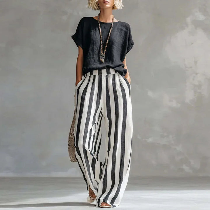 Striped women's linen summer set featuring a relaxed top and wide-leg pants. Breathable two-piece loungewear.