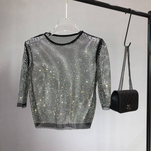 Stylish women's sparkle party top, versatile for festive wear and evenings. A glamorous shimmering t-shirt.