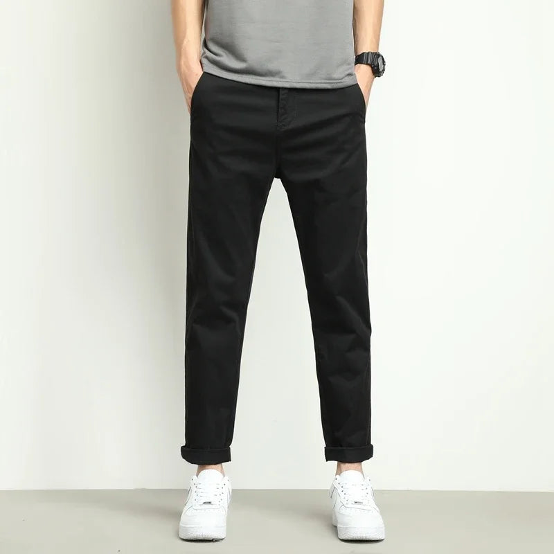 Black men's slim-fit performance tech trousers. Stretch and water-resistant for an active lifestyle.