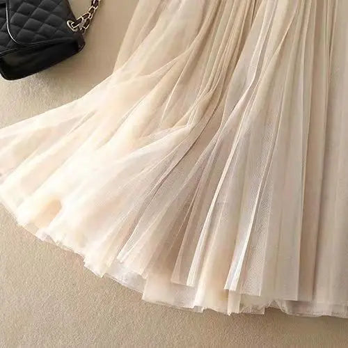 Modern women's pleated A-line midi skirt, high-waisted, flowy and elegant, a must-have for spring & summer styling.
