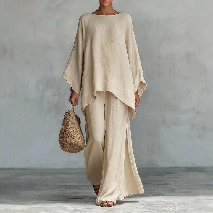 Women's relaxed linen two-piece set with wide-leg pants and an asymmetrical top, ideal for summer comfort.