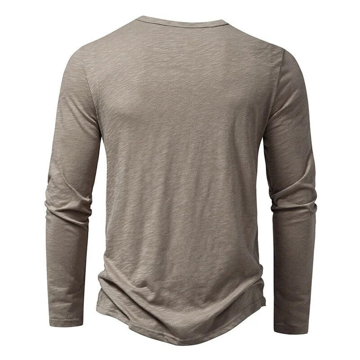 Versatile men's henley shirt with classic button placket. Slim fit, long sleeve casual wear.