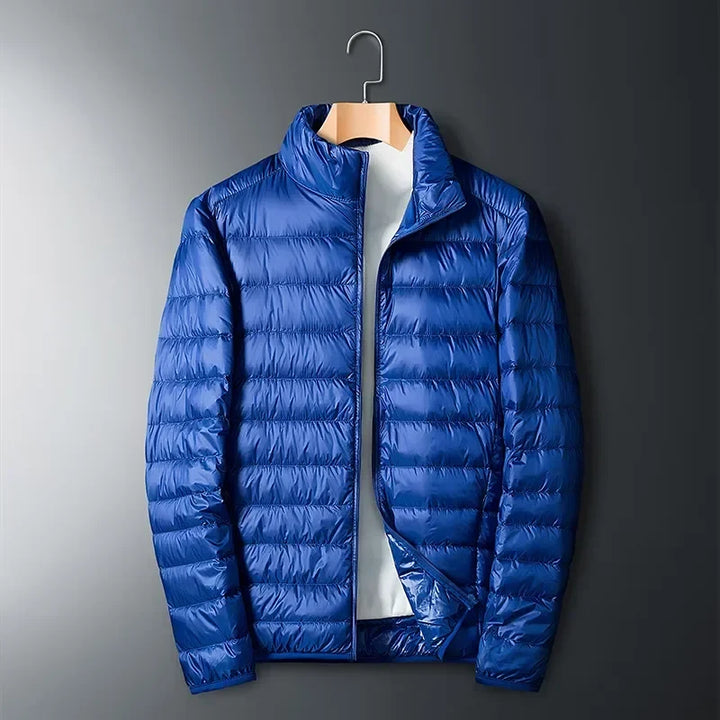 Vibrant red unisex packable puffer jacket. Lightweight, warm & waterproof for diverse outdoor travel & cold weather.